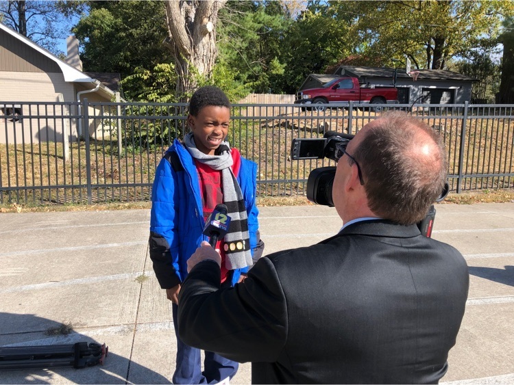 a student interviews with a reporter