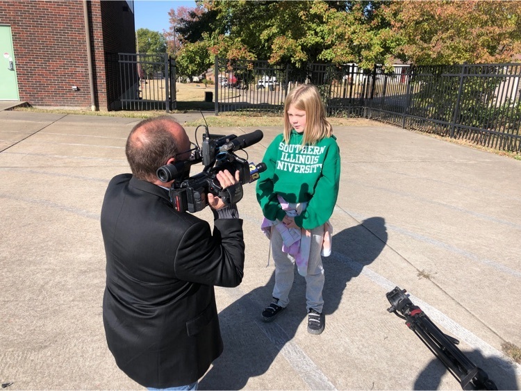 a student is interviewed by a reporter