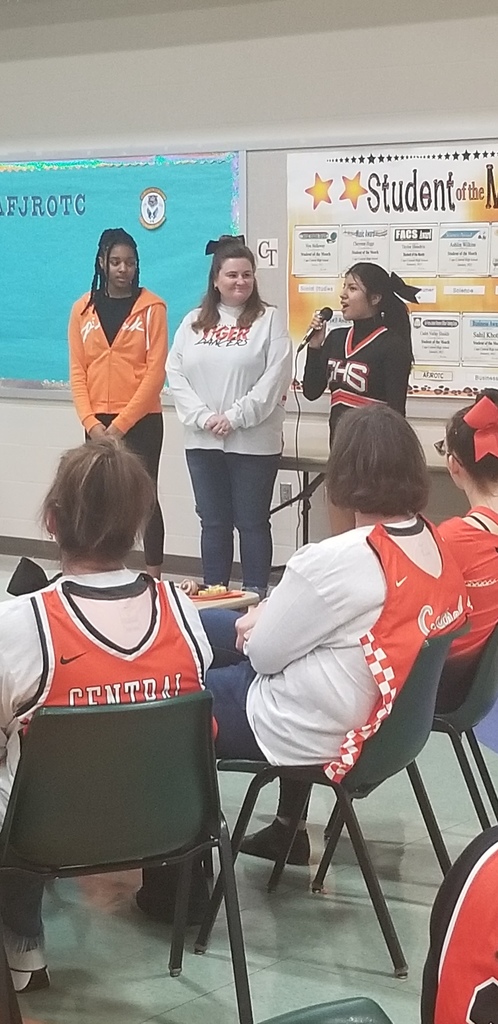 Mrs. Stausing being thanked by cheerleader and a dancer