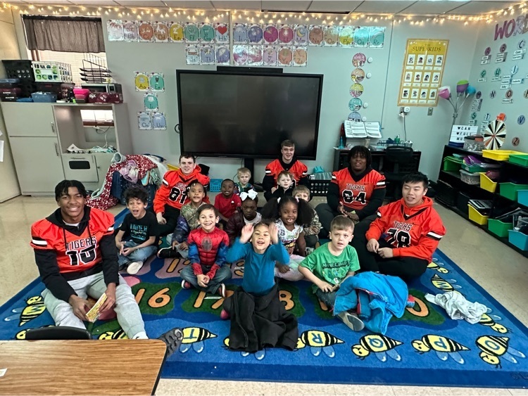 CHS football players pose with kindergarten students at Jefferson