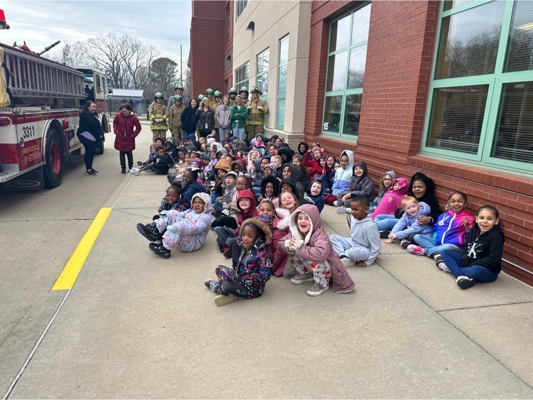 students at Franklin smile in front of the fire truck