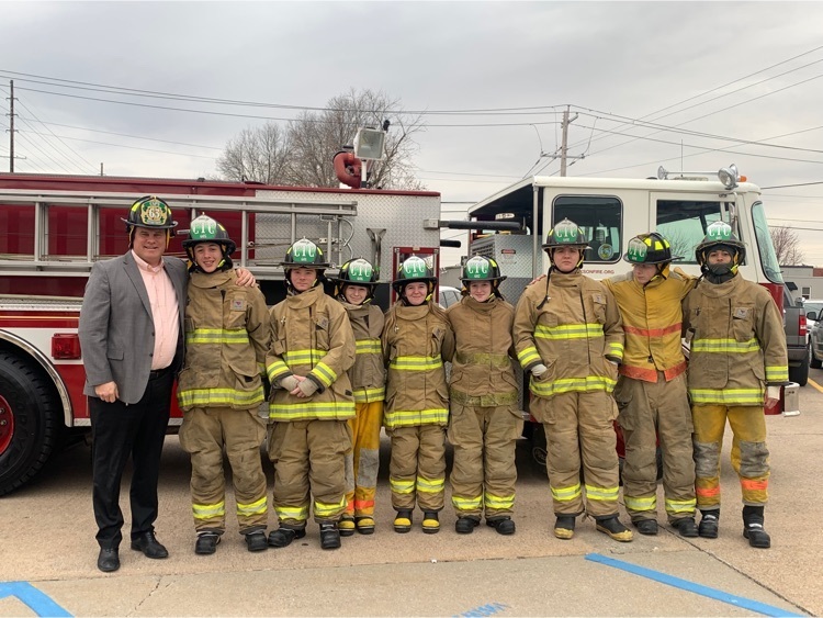 Dr. Glass poses with Fire Science students