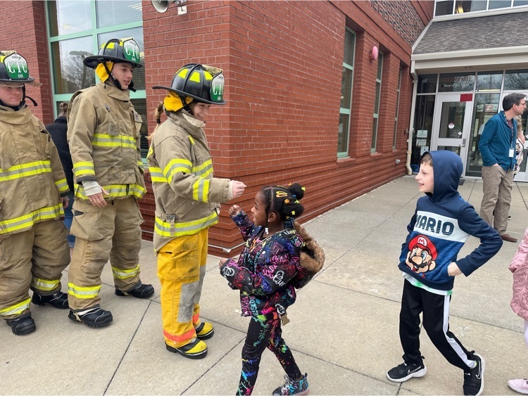 Fire Science students fist bump elementary students at Franklin 