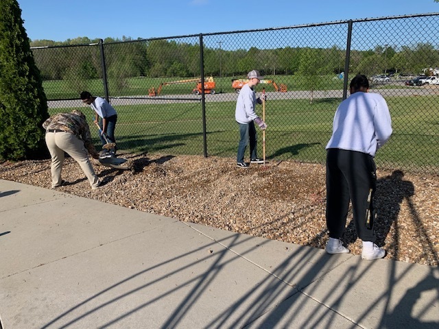 Students spread gravel.