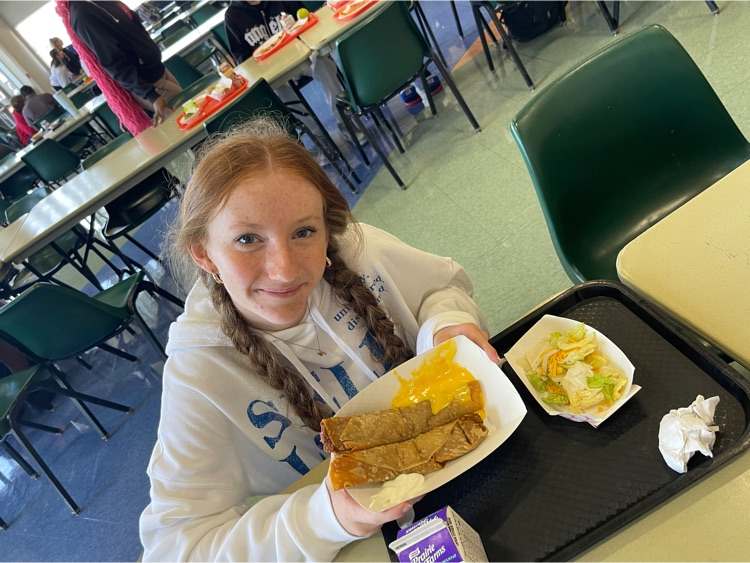a girl poses with a crispito meal at lunch