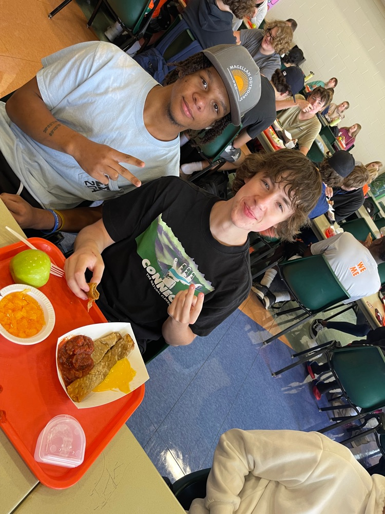 two boys pose in the lunch room 