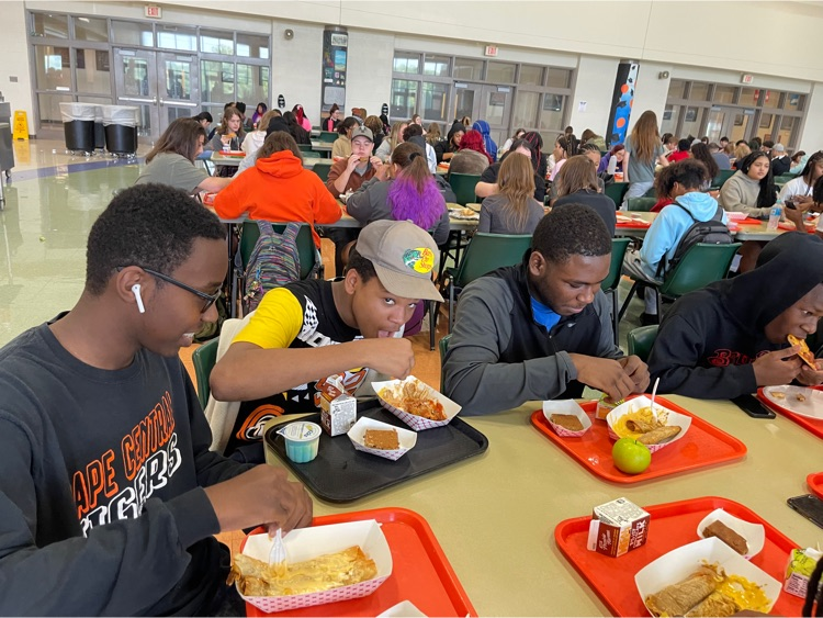 a group of students enjoy lunch together at a table 