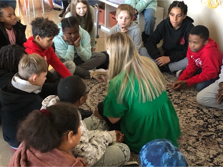 Mrs. Glueck introduces students to the bearded dragon 