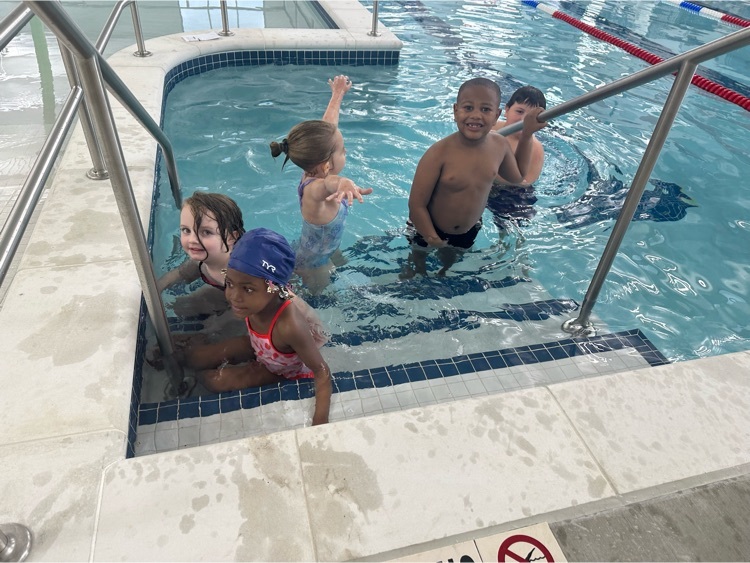 pre k students pose for a picture in the pool